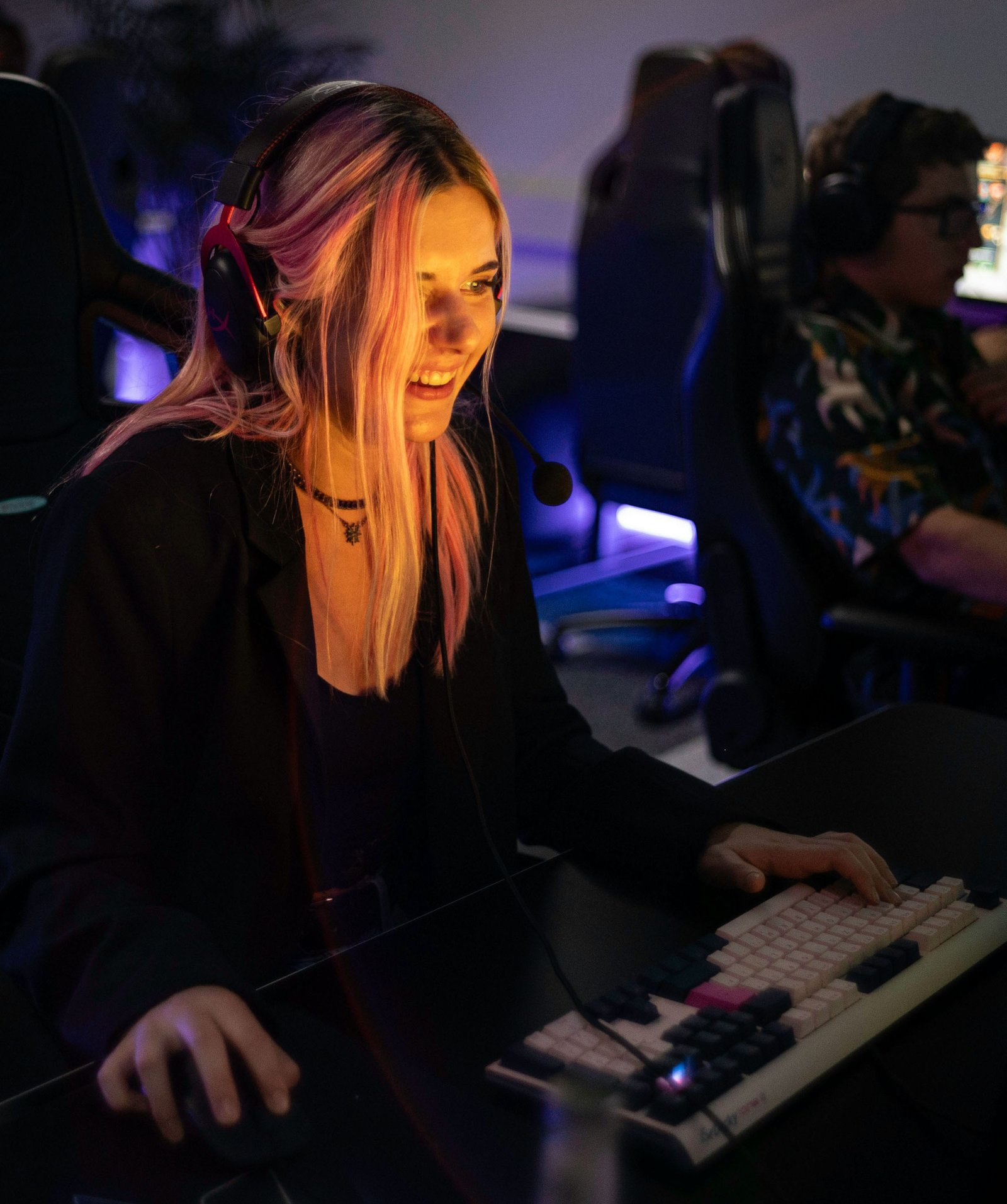 Female Player Playing Online with Keyboard and Headset
